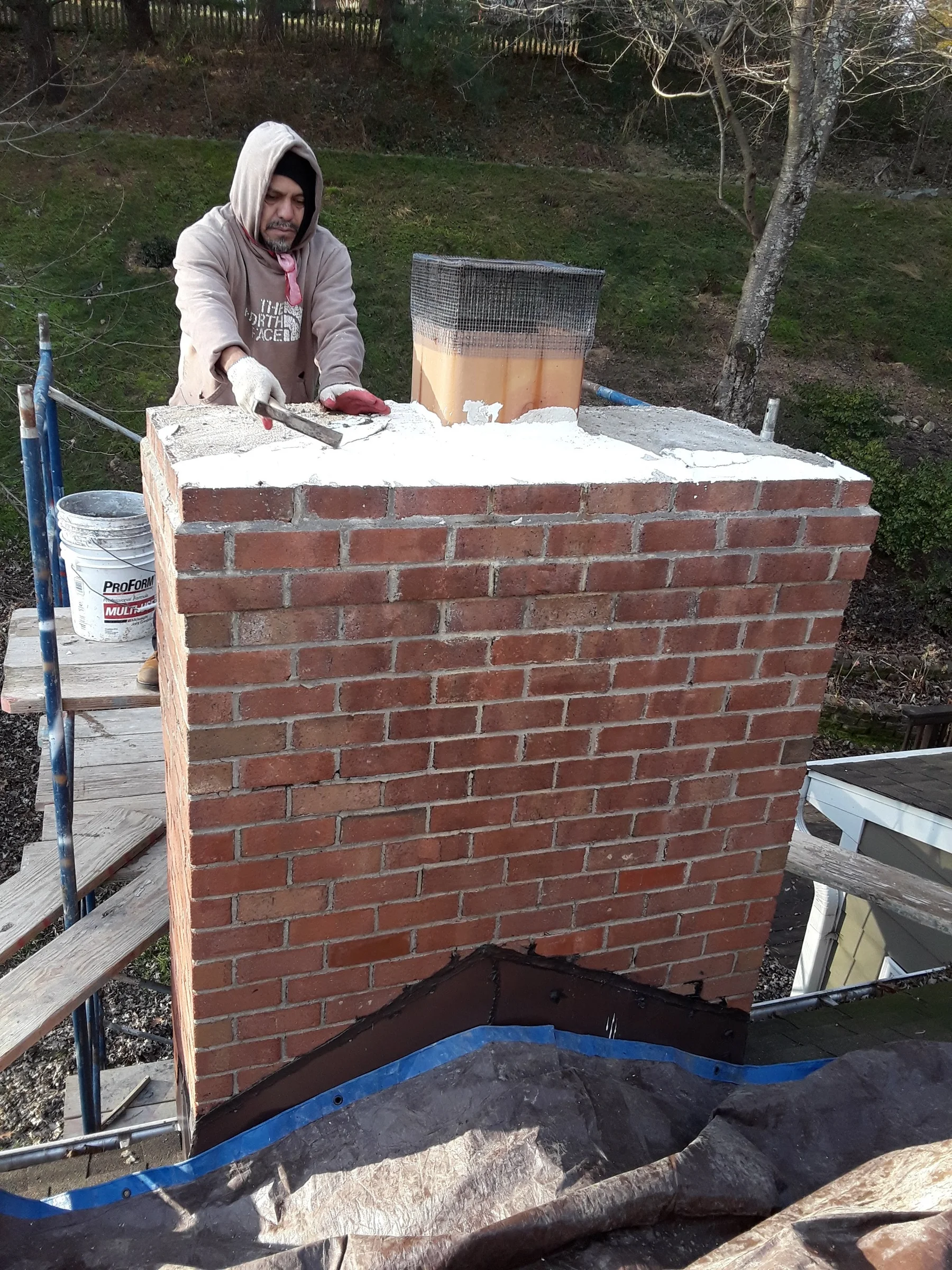 Brick chimney repair in progress