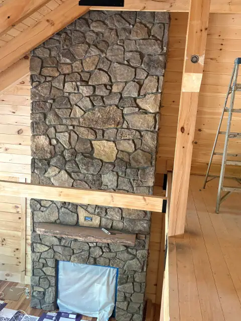 Indoor natural stone fireplace by F. Stone Designs