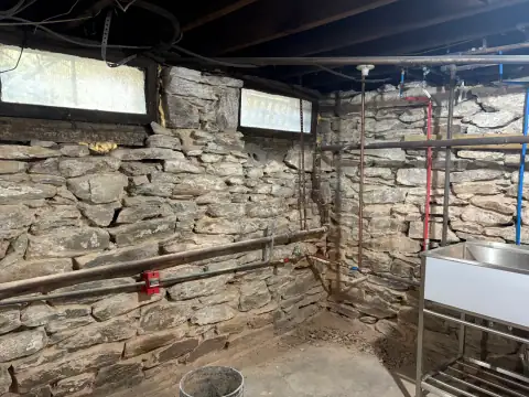 Basement stone wall restoration in progress