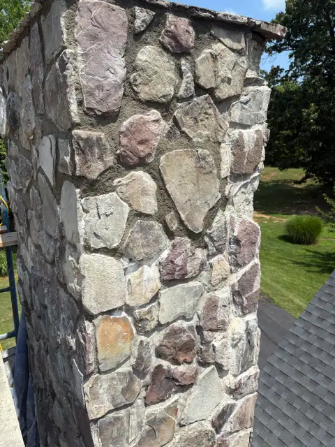 Stone chimney masonry repair view one