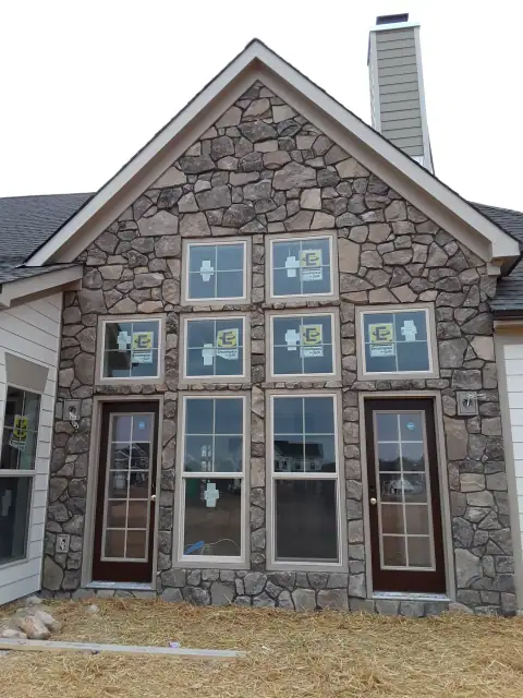 Completed multi-window stone house front