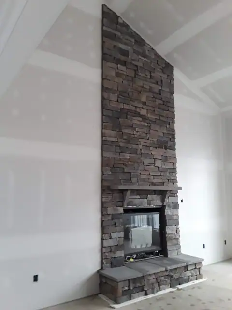 Indoor natural stone fireplace by F. Stone Designs