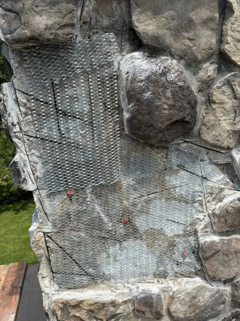 Damaged stone chimney before masonry repair