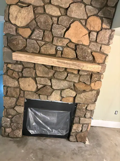 Indoor natural stone fireplace by F. Stone Designs