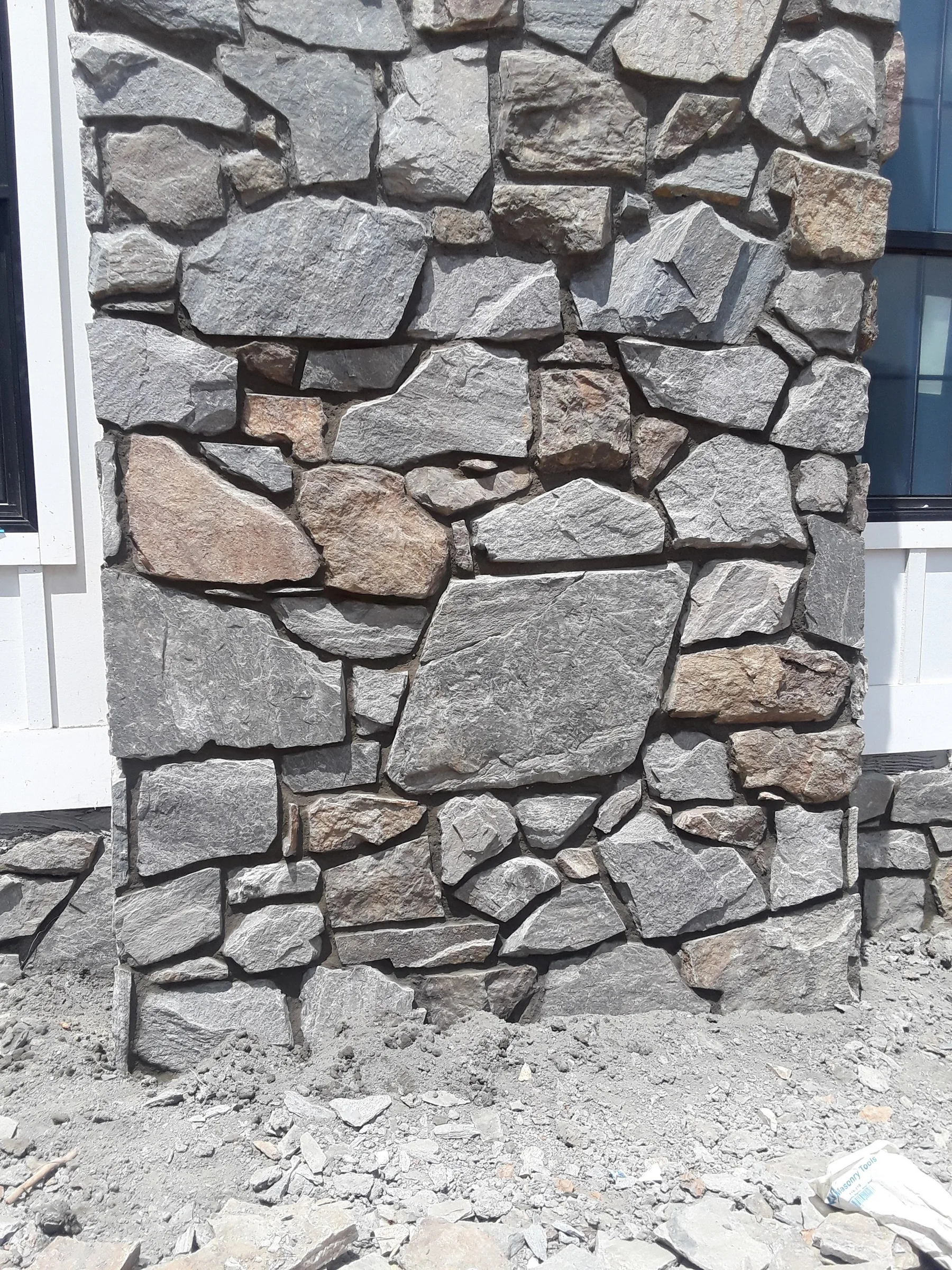 Natural stone texture and mortar joints on an exterior chimney