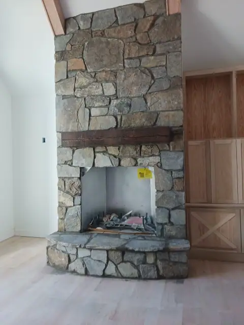 Indoor stone fireplace opening awaiting final insert
