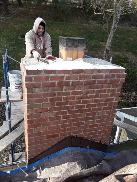 Brick chimney repair in progress