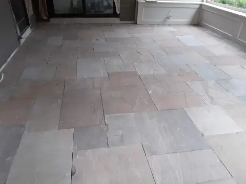 Large stone tiles on a covered patio