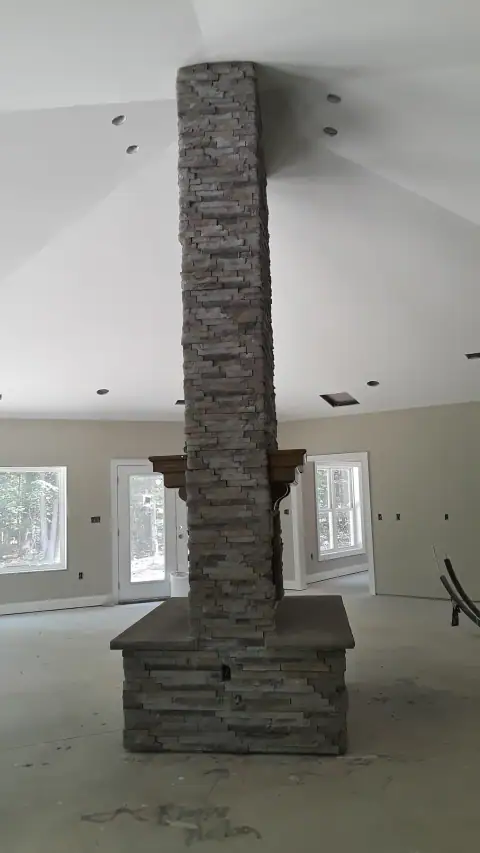Indoor natural stone fireplace by F. Stone Designs