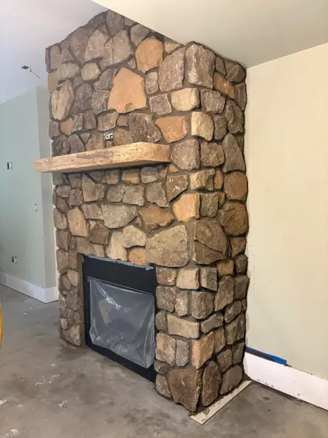 Indoor natural stone fireplace by F. Stone Designs