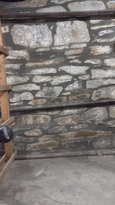 Detailed view of repointed stonework in a basement
