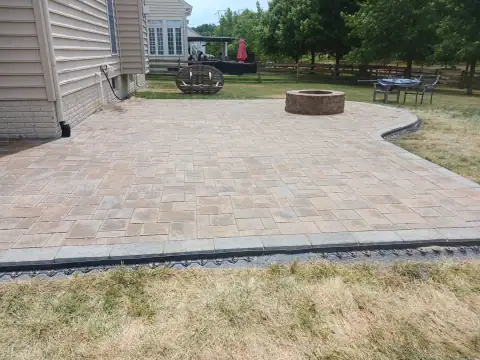 Outdoor stone fire pit and patio by F. Stone Designs