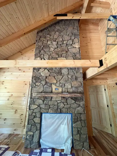 Indoor natural stone fireplace by F. Stone Designs