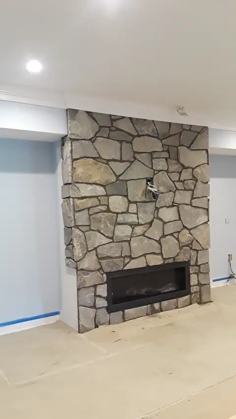 Indoor natural stone fireplace by F. Stone Designs