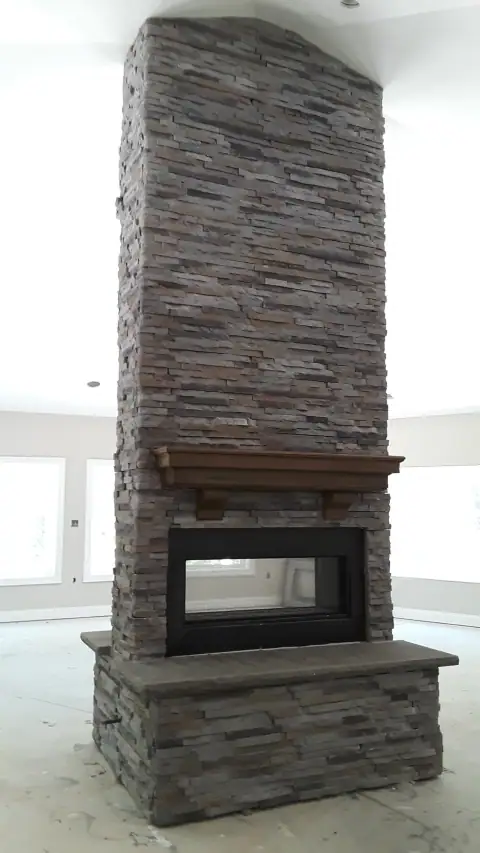 Indoor natural stone fireplace by F. Stone Designs