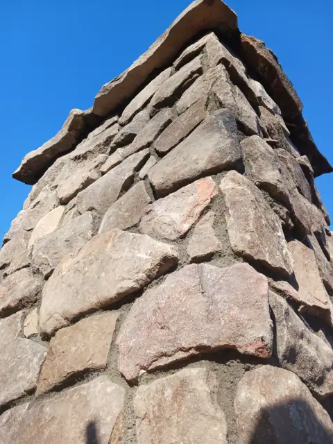 Close view of completed natural stone chimney masonry