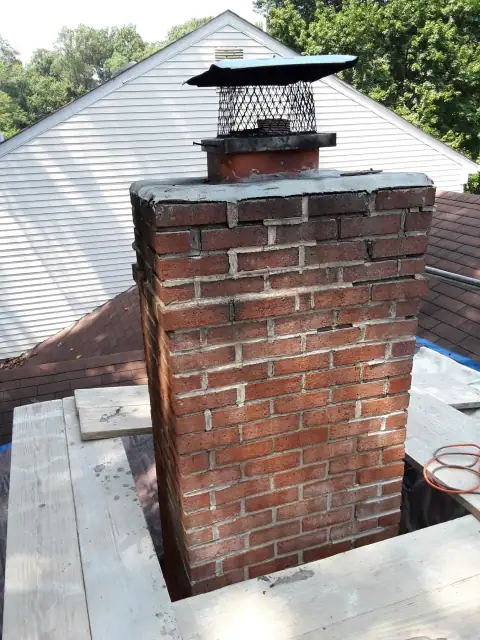Brick chimney mortar repair in progress