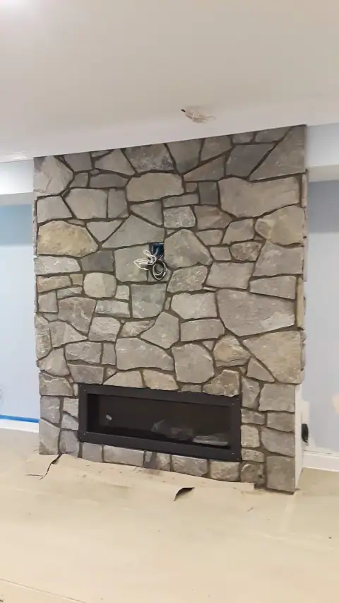 Indoor natural stone fireplace by F. Stone Designs