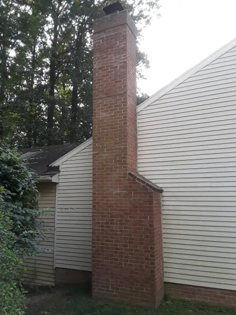 Brick chimney masonry repair in progress