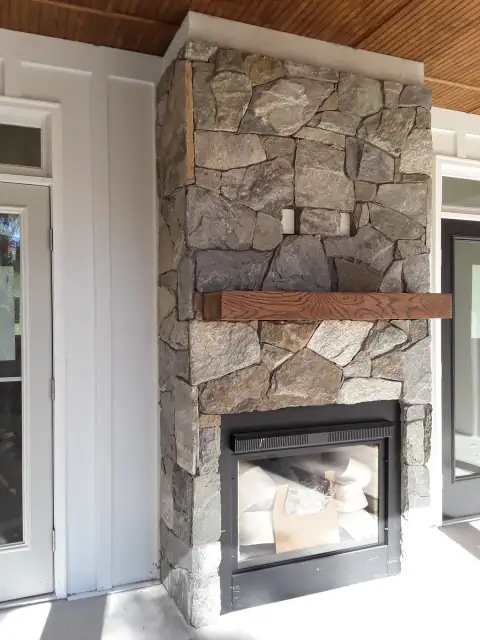 Indoor natural stone fireplace by F. Stone Designs