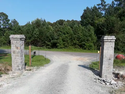 Finished stone entrance columns along a driveway